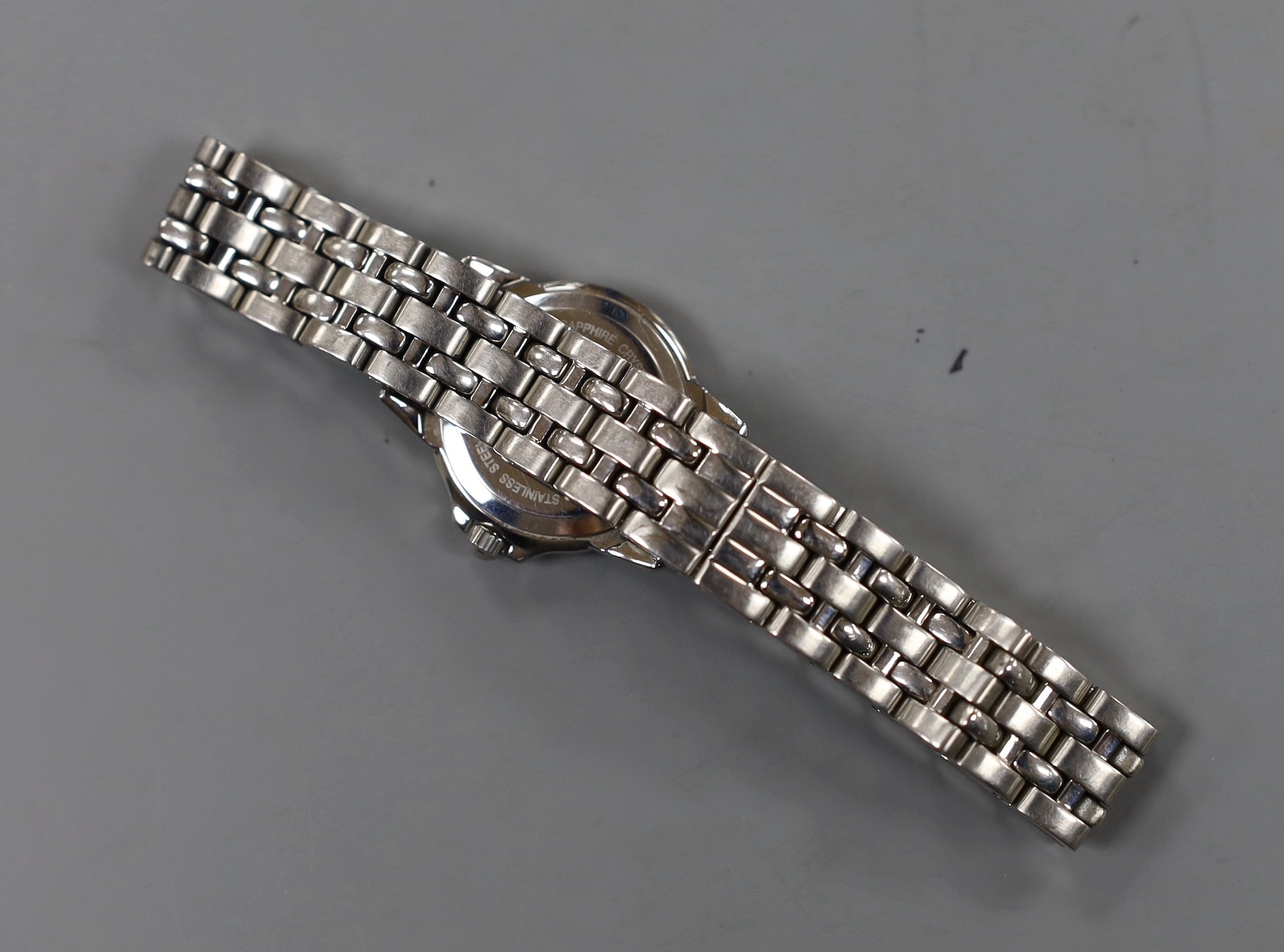 A lady's modern stainless steel Raymond Weil quartz wrist watch and bracelet, with diamond chip set bezel and mother of pearl dial with diamond set markers, with box.